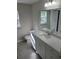 Bathroom with white vanity, a large mirror, and a tiled floor at 90 Bay Dr, Ocklawaha, FL 32179