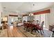 Cozy dining area featuring wood floors, a chandelier, and sliding glass doors with outside access at 973 Buster Pl, The Villages, FL 32162