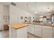 Bright kitchen featuring a center island with wood countertop and ample cabinet space, open to the living area at 973 Buster Pl, The Villages, FL 32162