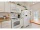 Functional kitchen with white appliances and a view to front door at 973 Buster Pl, The Villages, FL 32162