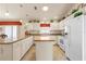 Well-lit kitchen featuring white cabinetry, modern appliances, and a skylight at 973 Buster Pl, The Villages, FL 32162