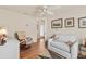 Cozy living room featuring a sofa, arm chair, wood floors and neutral paint, with a view to the front door at 973 Buster Pl, The Villages, FL 32162