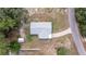 Aerial view of a well-maintained home and property including a driveway, shed, and tree coverage at 30 Maple Crse, Ocklawaha, FL 32179