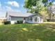Nice backyard showcasing a home with an enclosed sunroom, providing extra space and lots of natural light at 4360 Se 58Th Pl, Ocala, FL 34480