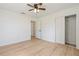 Bedroom featuring wood-look floors, a closet, and a ceiling fan at 4360 Se 58Th Pl, Ocala, FL 34480