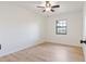 Bright bedroom featuring neutral walls, wood-look floors, and a ceiling fan at 4360 Se 58Th Pl, Ocala, FL 34480