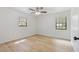 Bedroom featuring wood-look floors, a ceiling fan, and two windows at 4360 Se 58Th Pl, Ocala, FL 34480