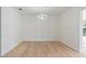 Open dining area featuring wood floors, white walls, and a chandelier at 4360 Se 58Th Pl, Ocala, FL 34480