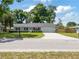 Charming home with a well-maintained lawn, neutral siding, and a wide driveway leading to an attached garage at 4360 Se 58Th Pl, Ocala, FL 34480