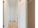 Bright hallway with wood-look flooring and white doors at 4360 Se 58Th Pl, Ocala, FL 34480
