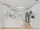 Bright kitchen featuring white cabinets, stainless appliances, and wood-look floors at 4360 Se 58Th Pl, Ocala, FL 34480