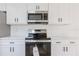 Kitchen featuring white cabinets, stainless appliances, and quartz countertops at 4360 Se 58Th Pl, Ocala, FL 34480