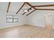 Open concept living room featuring stylish laminated flooring and vaulted ceiling with wooden beams at 4360 Se 58Th Pl, Ocala, FL 34480