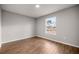 A bright bedroom with a large window and neutral walls, featuring wood-look tile flooring at 10927 Sw 42Nd Ave, Ocala, FL 34476