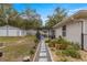 Large backyard featuring a patio, shed, and stepping stone pathway with rock beds at 19370 Saint Benedict Dr, Dunnellon, FL 34432