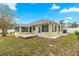 The backyard features a small deck and fully enclosed sunroom, surrounded by mature landscaping at 4219 Ne 33Rd Ave, Ocala, FL 34479