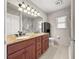 Well-lit bathroom featuring a double vanity with a granite countertop and plenty of storage at 4219 Ne 33Rd Ave, Ocala, FL 34479