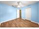 Bright bedroom with laminate wood flooring, a ceiling fan and closet at 4219 Ne 33Rd Ave, Ocala, FL 34479