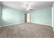 Spacious bedroom with a ceiling fan, neutral carpet, and light blue walls for a soothing ambiance at 4219 Ne 33Rd Ave, Ocala, FL 34479