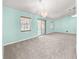 Spacious living room illuminated by a modern chandelier and natural light from a sliding glass door at 4219 Ne 33Rd Ave, Ocala, FL 34479