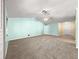 Large carpeted living room with ceiling fan and multiple entryways creating an open and airy feel at 4219 Ne 33Rd Ave, Ocala, FL 34479
