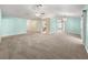 Expansive living area with a ceiling fan, stylish lighting, neutral paint, and a mix of wood and carpeted floors at 4219 Ne 33Rd Ave, Ocala, FL 34479