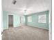 Large primary bedroom with neutral carpet, windows, walk-in closet, and ceiling fan at 4219 Ne 33Rd Ave, Ocala, FL 34479