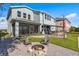 Beautiful backyard featuring a fire pit, screened in patio, outdoor kitchen and manicured lawn at 455 Blue Cypress Dr, Groveland, FL 34736