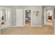 Spacious hallway with neutral walls and carpet, leading to bedrooms and living areas providing a warm and inviting atmosphere at 455 Blue Cypress Dr, Groveland, FL 34736