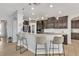 Modern kitchen boasts stainless steel appliances, granite countertops, pendant lighting and a breakfast bar with seating at 455 Blue Cypress Dr, Groveland, FL 34736