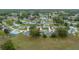 This aerial view showcases the neighborhood with lush greenery and well-maintained homes in a quiet community at 8150 Sw 108Th St, Ocala, FL 34481