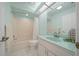 Well-maintained bathroom features a shower and bathtub with white tiled flooring and a large vanity at 8150 Sw 108Th St, Ocala, FL 34481