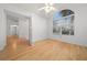 Bedroom boasts hardwood floors, neutral walls, a ceiling fan, and a large window at 8150 Sw 108Th St, Ocala, FL 34481