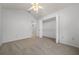 Neutral carpeted bedroom with a ceiling fan and closet featuring ample shelving space at 8150 Sw 108Th St, Ocala, FL 34481