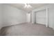 Large bedroom features neutral carpet, a ceiling fan, and an open closet with shelving at 8150 Sw 108Th St, Ocala, FL 34481