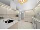 Well-lit kitchen featuring white cabinets, quartz countertops, tile floors, and modern appliances at 8150 Sw 108Th St, Ocala, FL 34481