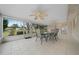 Spacious screened-in porch featuring ceiling fans and room for outdoor dining overlooking a well manicured lawn at 8150 Sw 108Th St, Ocala, FL 34481