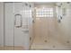 Updated shower showcasing glass enclosure, marble tiles, and window allowing natural light at 8150 Sw 108Th St, Ocala, FL 34481