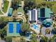 Aerial view of community amenities including a pool, tennis courts, bocce ball court and clubhouse at 10927 Se 168Th Loop, Summerfield, FL 34491