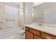 Neutral-toned full bathroom with a shower and a wooden vanity at 10927 Se 168Th Loop, Summerfield, FL 34491