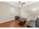 Bedroom with hardwood floors, and a ceiling fan, furnished with a black futon at 10927 Se 168Th Loop, Summerfield, FL 34491