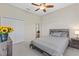 Cozy bedroom with a ceiling fan, a wood headboard bed, and an abundance of natural light at 10927 Se 168Th Loop, Summerfield, FL 34491