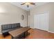 Bedroom features a ceiling fan, hardwood floors and a large closet at 10927 Se 168Th Loop, Summerfield, FL 34491