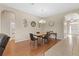 Dining area with hardwood floors, chandelier lighting, and adjacent living areas, ideal for Gathering dinners and gatherings at 10927 Se 168Th Loop, Summerfield, FL 34491