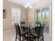Cozy dining area with a glass table, seating for four, and sliding glass doors to the patio at 10927 Se 168Th Loop, Summerfield, FL 34491
