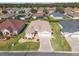 Aerial view of a single-story home with a well-manicured lawn, landscaped front yard, and a driveway with a star design at 10927 Se 168Th Loop, Summerfield, FL 34491