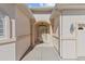 Inviting front entrance with stucco walls, columns, a transom window, and decorative lighting, adding charm and curb appeal at 10927 Se 168Th Loop, Summerfield, FL 34491