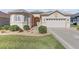 Charming home with an attached garage, a manicured lawn, and manicured shrubs at 10927 Se 168Th Loop, Summerfield, FL 34491