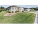 Well-manicured front yard with green lawn, landscaping and an attractive home at 10927 Se 168Th Loop, Summerfield, FL 34491