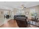 Spacious living room featuring hardwood floors, plantation shutters, and comfortable seating arrangement at 10927 Se 168Th Loop, Summerfield, FL 34491
